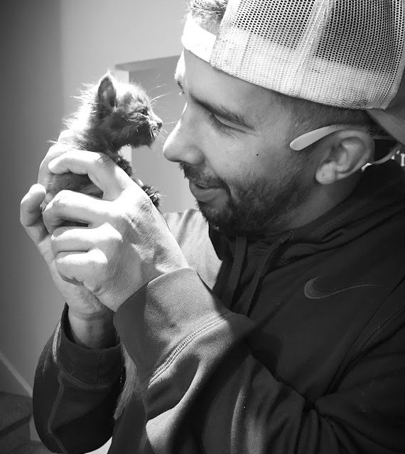 smiling foster parent with kitten