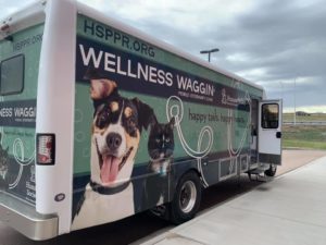 HSPPR wellness bus with smiling dog and black cat