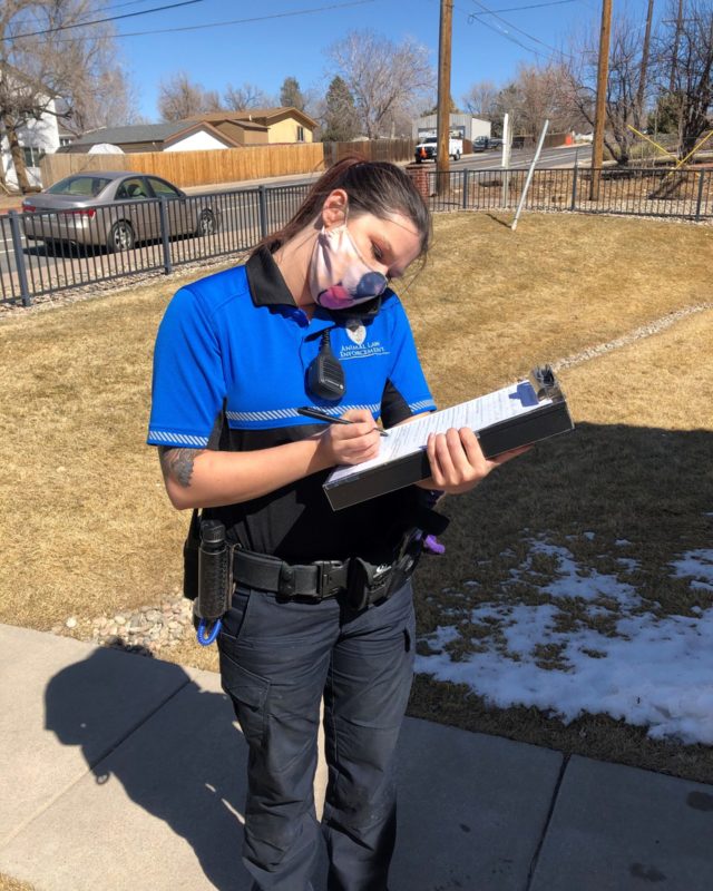 HSPPR ALE Officer wearing a dog face mask takes notes on her clipboard